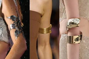 Bracelet porté au bras en forme d'étoile argent et les deux autres dorés.
